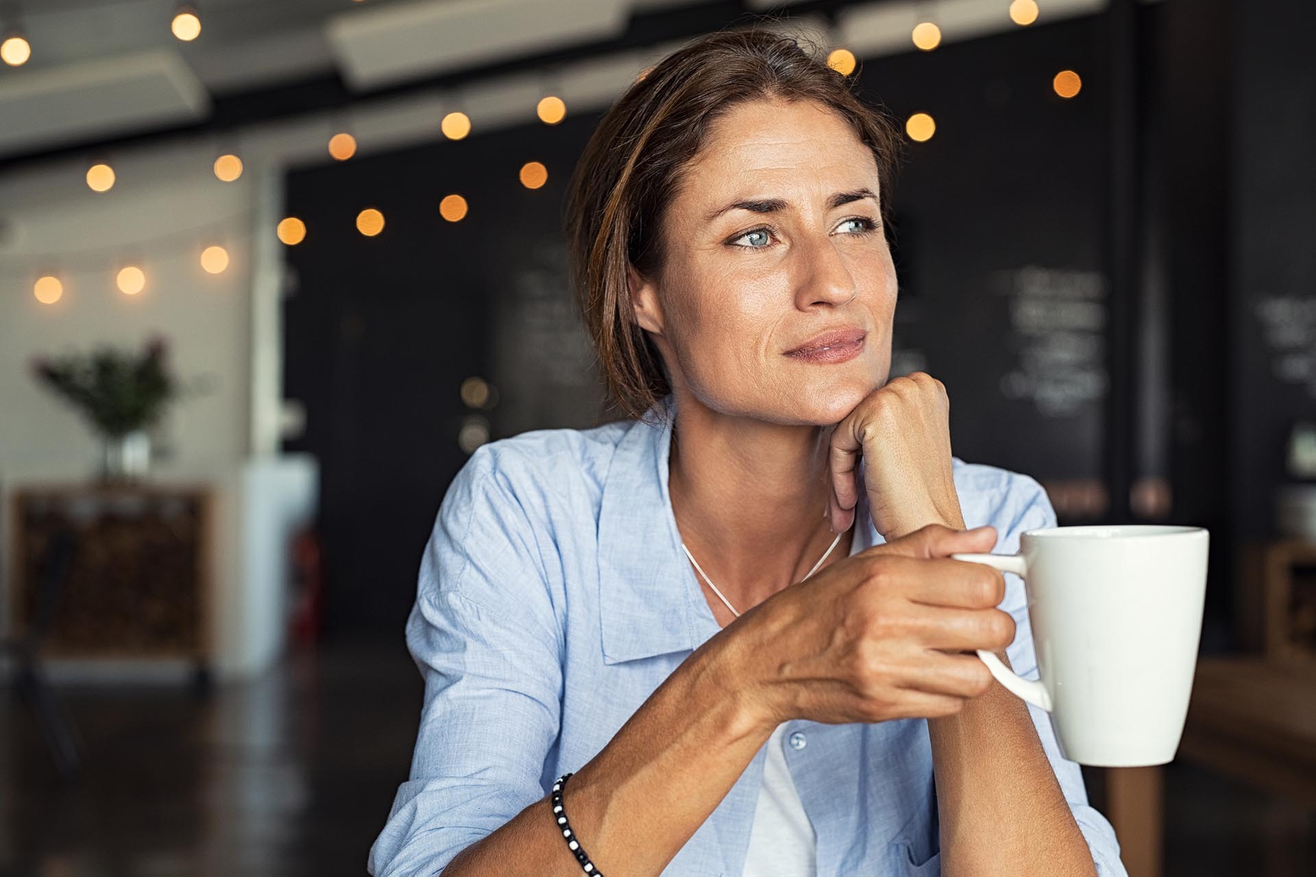 Aging woman holding coffee mug