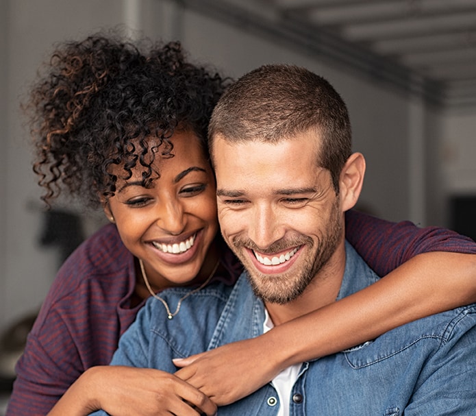 Smiling-young-couple-embracing